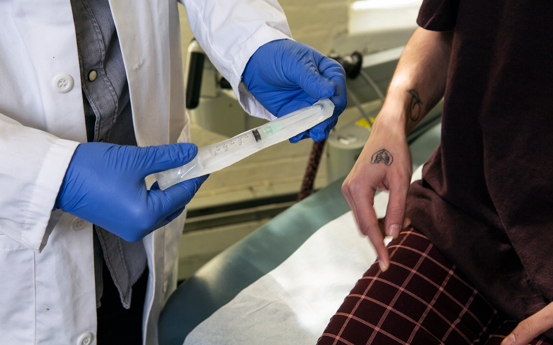 a doctor shows a patient a syringe