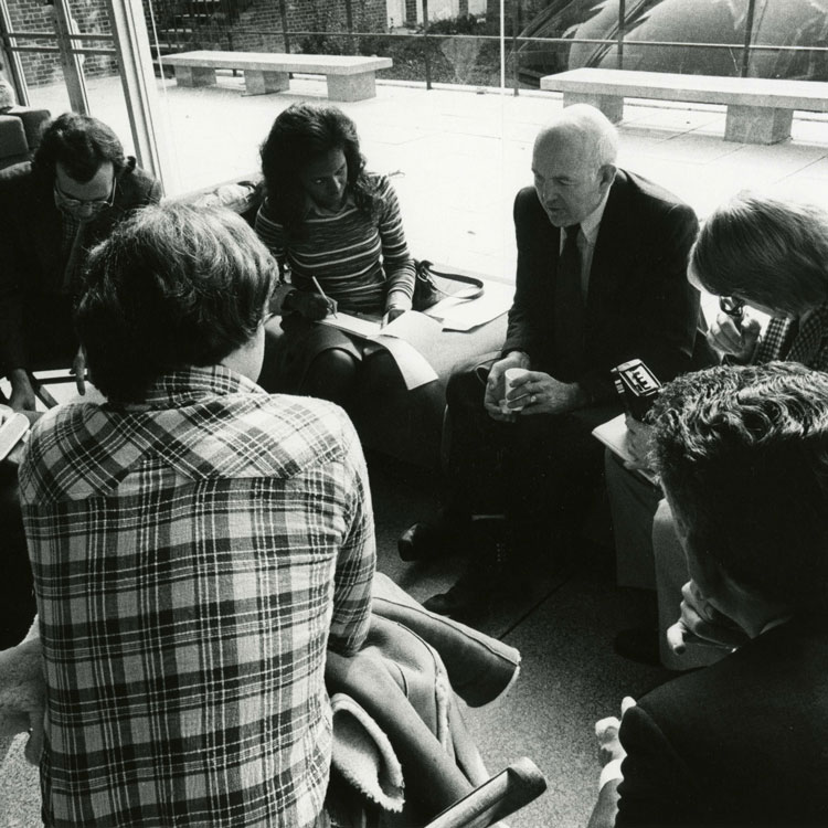 Coleman sitting with students inside the Glass Pavilion