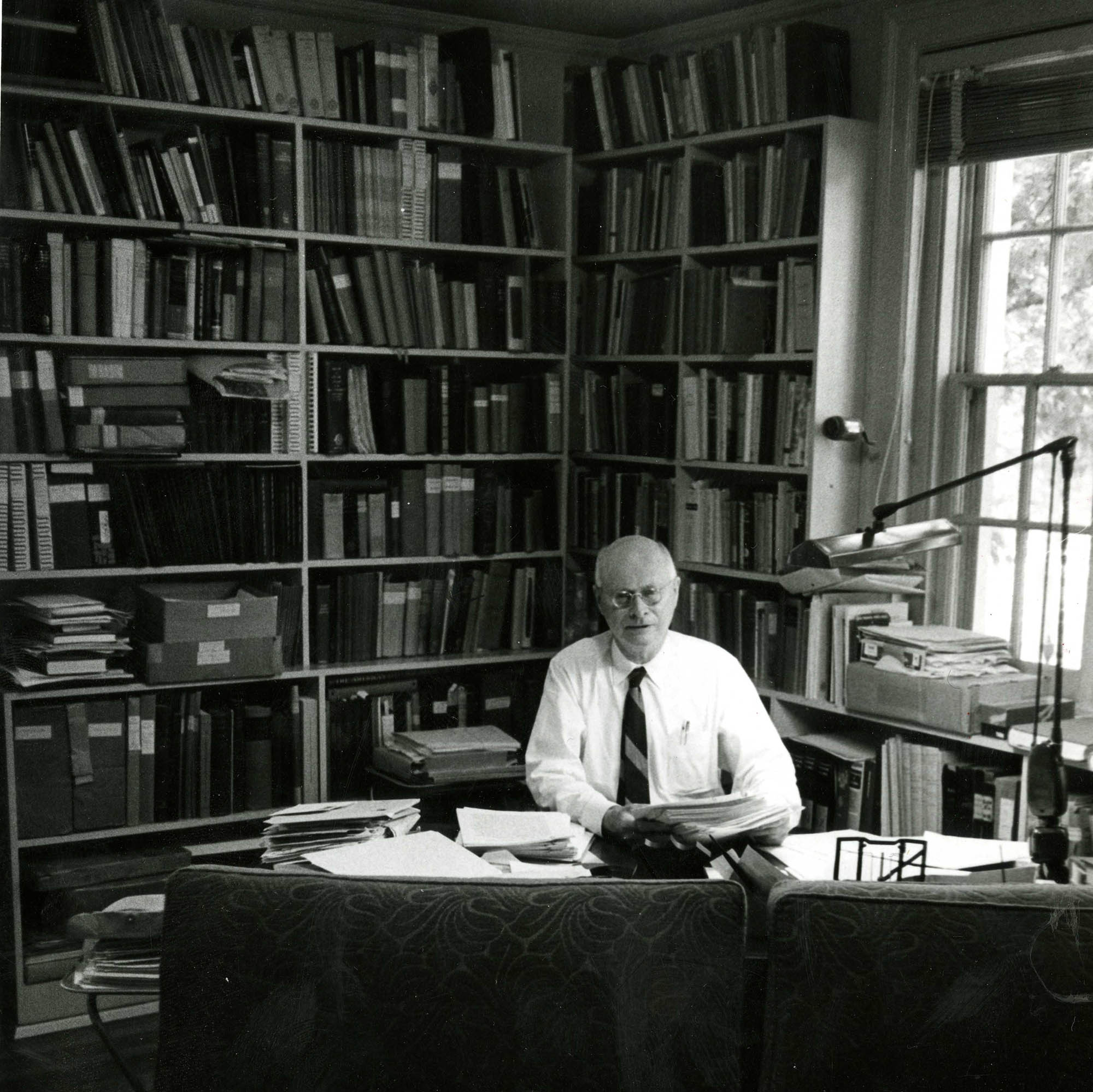Candid photograph of Albright at approximately 70 years old at his desk