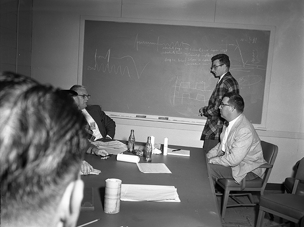 Sputnik satellite tracking discussion; Henry B. Riblet, Robert W. Bogle, William H. Guier (standing).