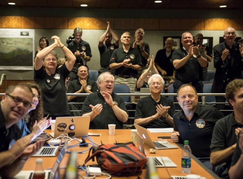 Members of the New Horizons science team react to seeing the spacecraft's last and sharpest image of Pluto at the Johns Hopkins University Applied Physics Laboratory.